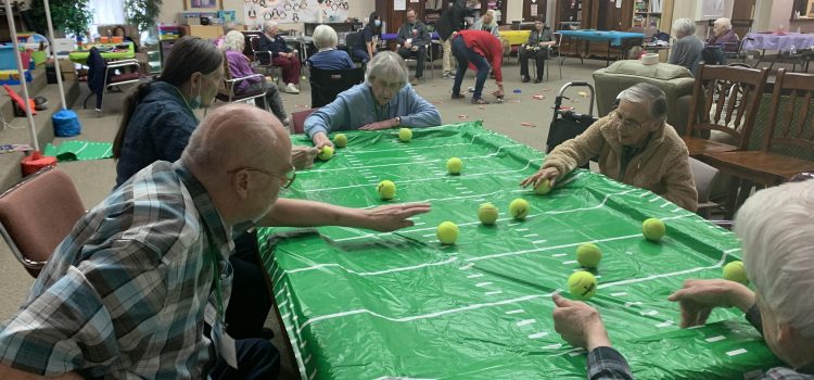 Elderly Clients at Aspen Senior Day Center Play A table-top game at the Center in Provo, Utah.